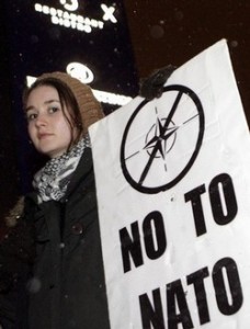 A protester holds an anti-NATO sign in Reikjavik January 27, 2009. NATO seminar on Security Prospects in the High North, hosted by the Icelandic Government will be held on Thursday. REUTERS/Ints Kalnins (ICELAND)